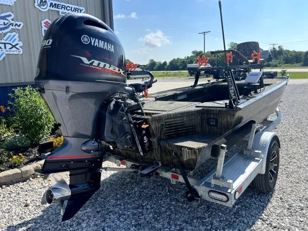 Rear seating area of the 2023 Prodigy Villain 1751 at Waypoint Marine, highlighting plush grey upholstery, cup holders, and integrated storage compartments